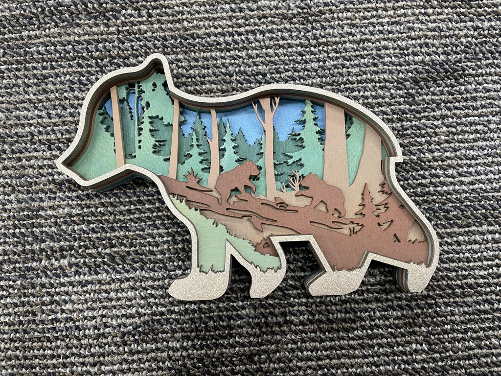 Wooden laser-cut bear cub with cute scene inside