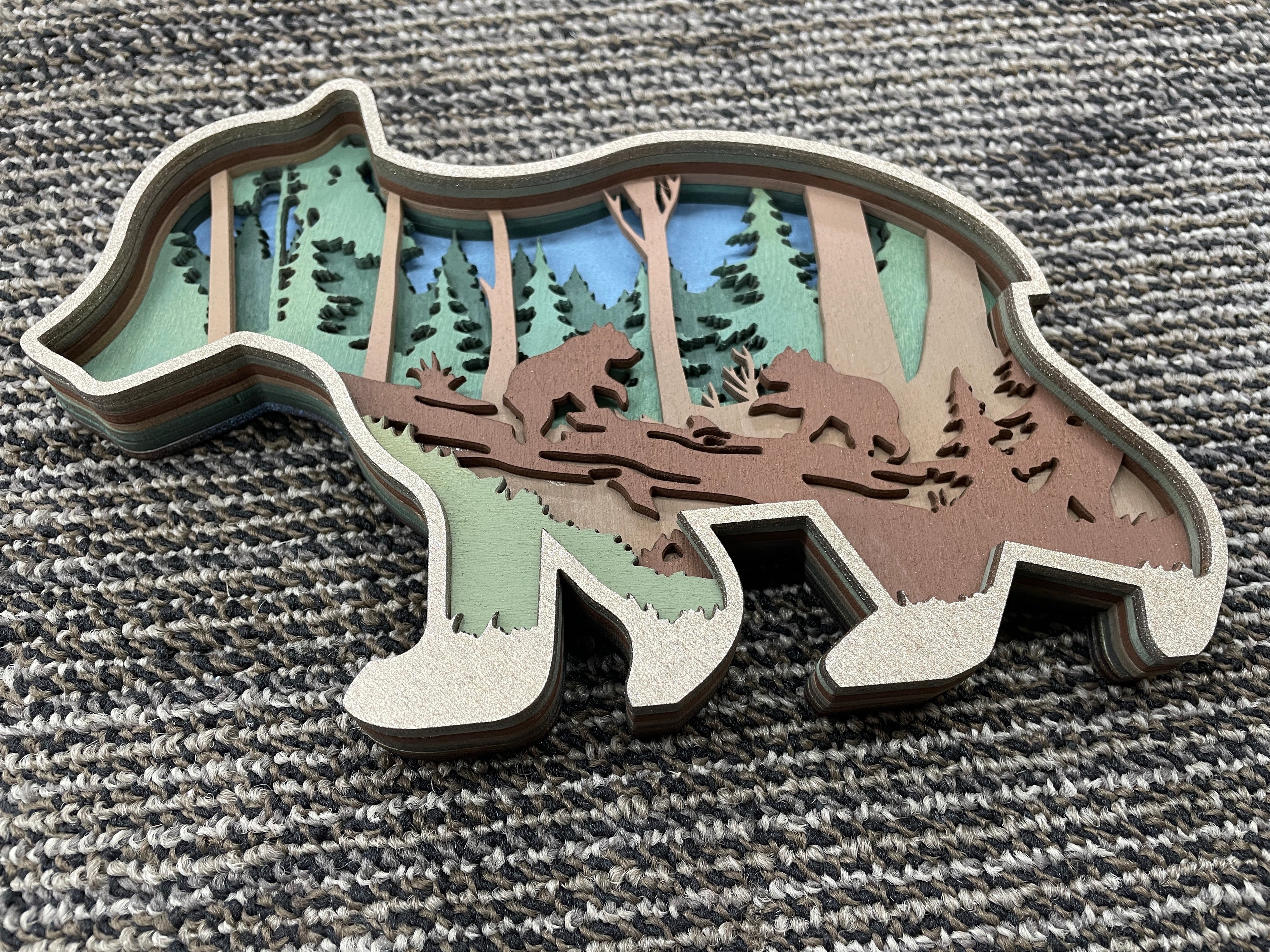 Wooden laser-cut bear cub with cute scene inside